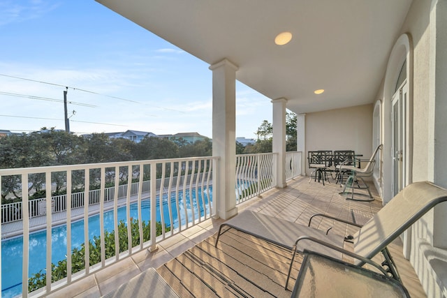 balcony with a fenced in pool