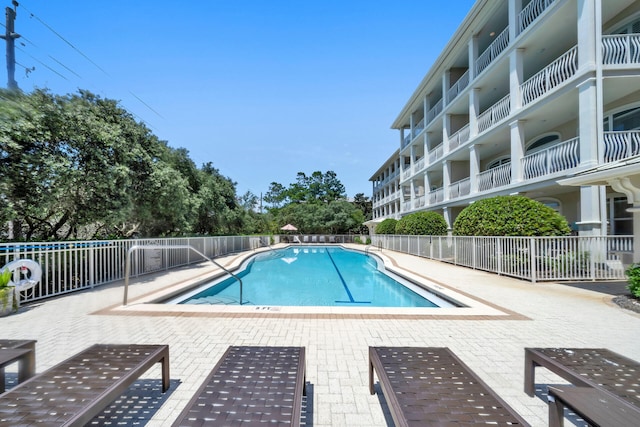 view of swimming pool featuring a patio area