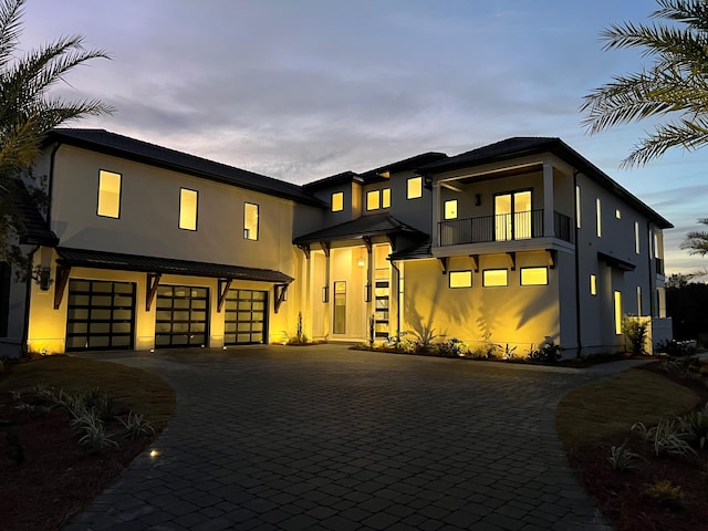 modern home with a garage and a balcony