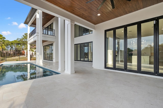 view of swimming pool featuring ceiling fan and a patio area