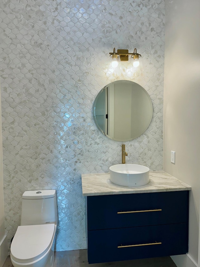 bathroom featuring vanity and toilet