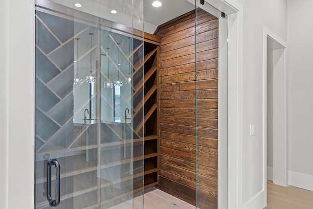 interior space featuring hardwood / wood-style flooring and a shower with door