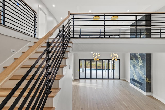 330 Kelly Plantation Dr, Destin, FL 32541 - stairway featuring a chandelier, baseboards, wood finished floors, and recessed lighting