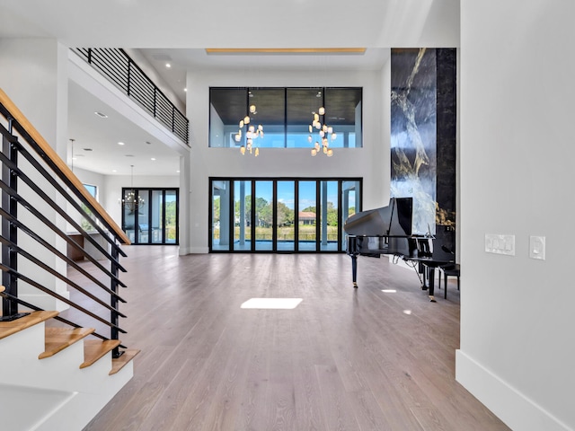 330 Kelly Plantation Dr, Destin, FL 32541 - entryway with stairway, a chandelier, wood finished floors, healthy amount of natural light, and a high ceiling