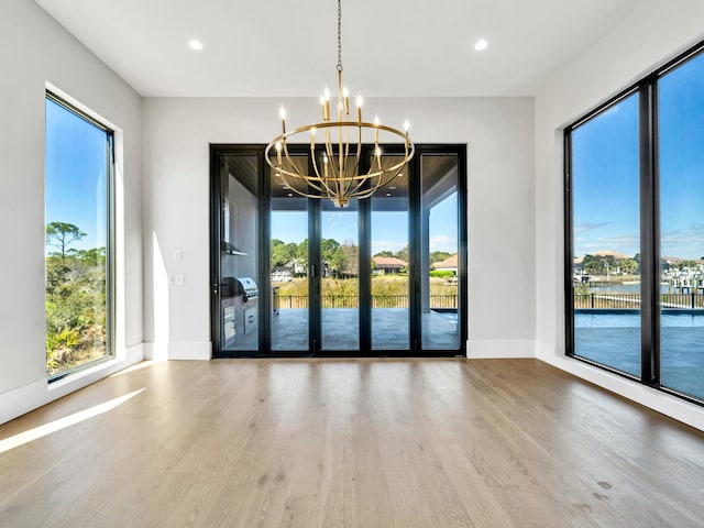 330 Kelly Plantation Dr, Destin, FL 32541 - unfurnished dining area featuring a chandelier, wood finished floors, baseboards, and recessed lighting
