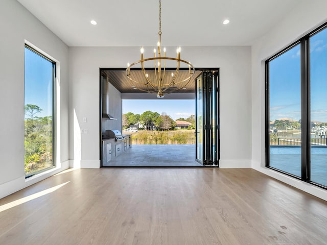 330 Kelly Plantation Dr, Destin, FL 32541 - unfurnished dining area with wood finished floors, a chandelier, healthy amount of natural light, and recessed lighting