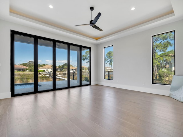 330 Kelly Plantation Dr, Destin, FL 32541 - empty room with a raised ceiling, a ceiling fan, wood finished floors, recessed lighting, and baseboards