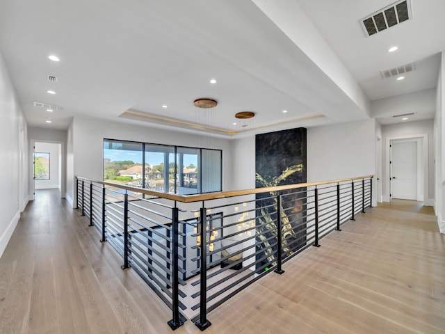 330 Kelly Plantation Dr, Destin, FL 32541 - corridor with wood finished floors, baseboards, a tray ceiling, an upstairs landing, and recessed lighting