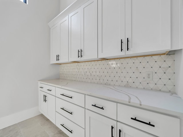 330 Kelly Plantation Dr, Destin, FL 32541 - kitchen with light stone countertops, decorative backsplash, and white cabinets