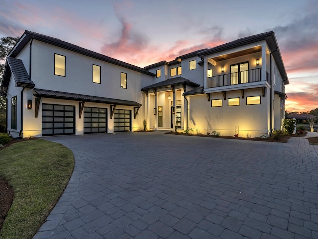 330 Kelly Plantation Dr, Destin, FL 32541 - modern home with stucco siding, decorative driveway, a garage, a balcony, and a standing seam roof