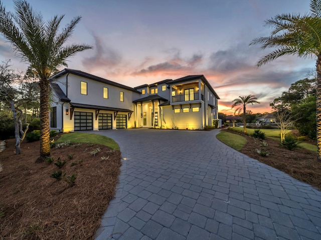 330 Kelly Plantation Dr, Destin, FL 32541 - modern home with stucco siding, curved driveway, a garage, and a balcony