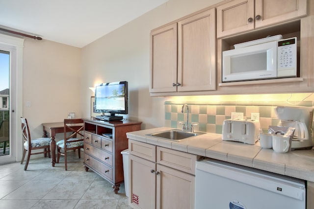 kitchen with backsplash, white appliances, light tile flooring, tile countertops, and sink