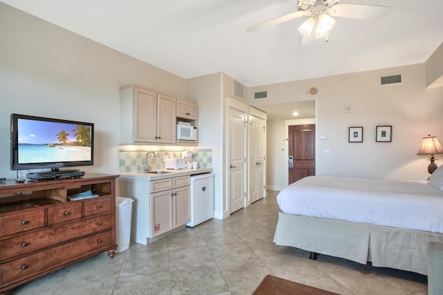 tiled bedroom featuring sink and ceiling fan