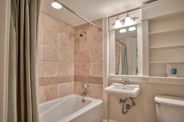 full bathroom featuring sink, shower / bathtub combination with curtain, and toilet