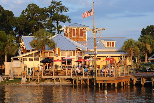 rear view of house featuring a deck with water view