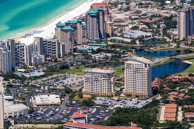 bird's eye view with a water view and a beach view