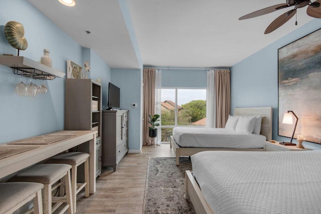 bedroom featuring ceiling fan and light wood-type flooring