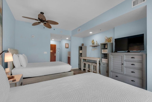 bedroom featuring wood-type flooring, ceiling fan, and ensuite bathroom