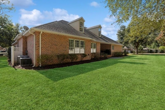 back of house with central AC and a yard