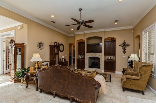 living room with ceiling fan, crown molding, and light tile flooring