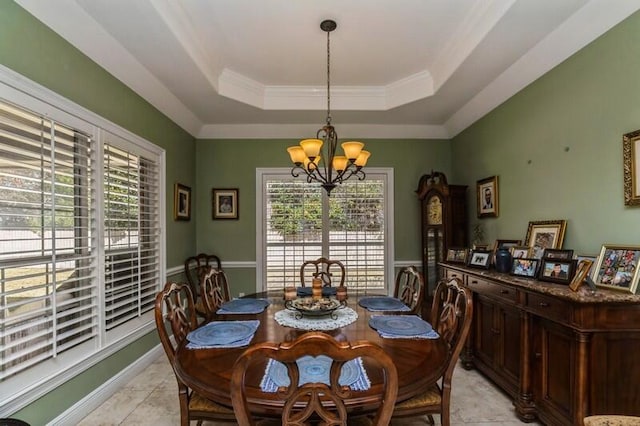 dining space featuring an inviting chandelier, a raised ceiling, and light tile floors