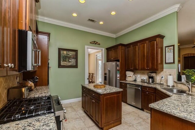 kitchen featuring light tile flooring, light stone countertops, stainless steel appliances, sink, and tasteful backsplash