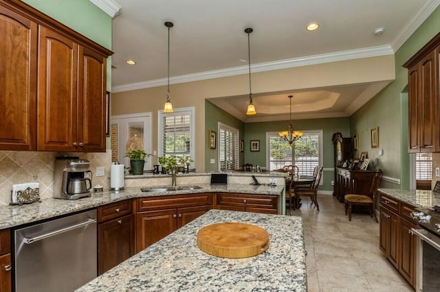 kitchen featuring stainless steel dishwasher, sink, a chandelier, and decorative light fixtures