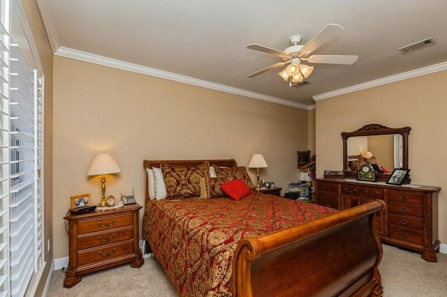 carpeted bedroom featuring ceiling fan and crown molding