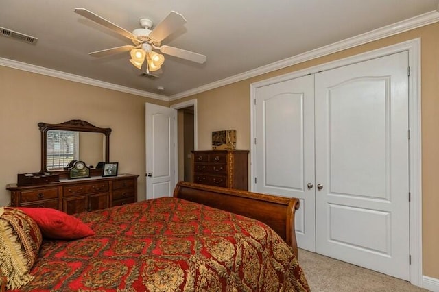 carpeted bedroom featuring a closet, ceiling fan, and crown molding