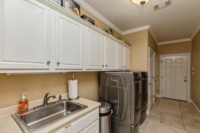 washroom with washer and clothes dryer, ornamental molding, light tile floors, sink, and cabinets