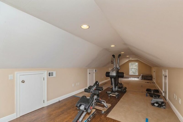 exercise area with vaulted ceiling and dark hardwood / wood-style floors