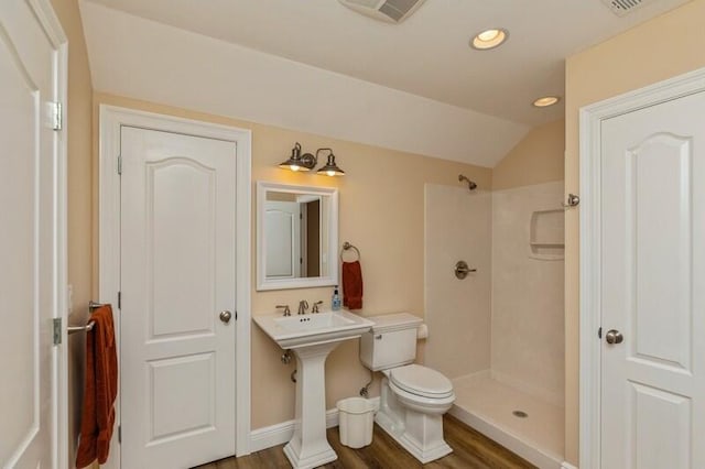 bathroom featuring walk in shower, wood-type flooring, sink, vaulted ceiling, and toilet