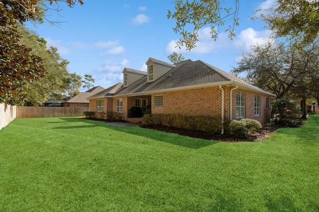 rear view of property with a yard