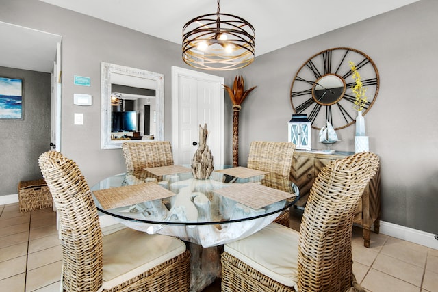 dining room with a notable chandelier and light tile flooring