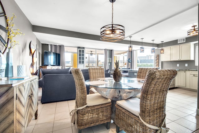 tiled dining space with an inviting chandelier