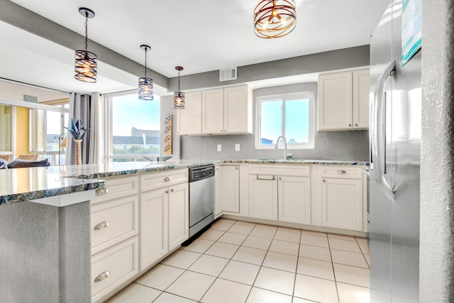 kitchen featuring a healthy amount of sunlight, stainless steel appliances, kitchen peninsula, and decorative light fixtures