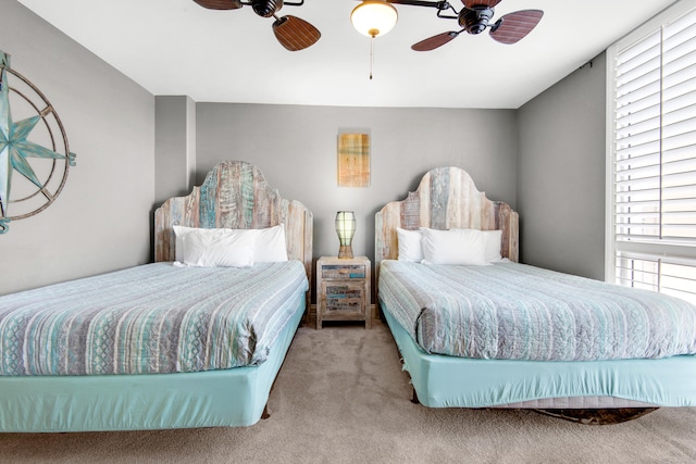 bedroom featuring light colored carpet and ceiling fan