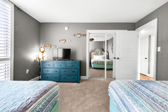 bedroom with light colored carpet and a closet