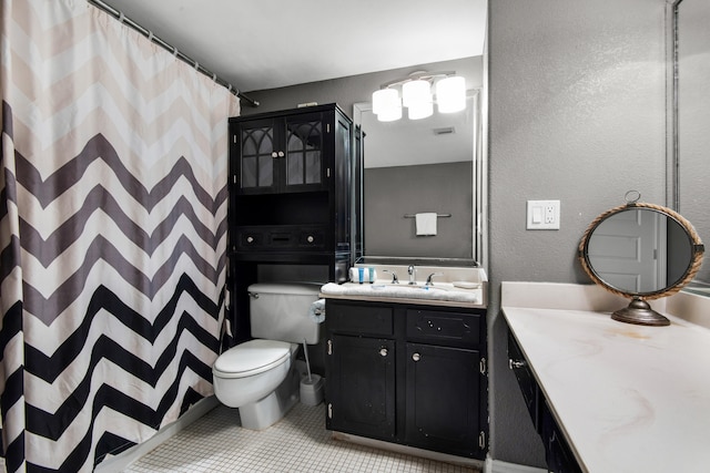 bathroom with tile floors, toilet, and oversized vanity