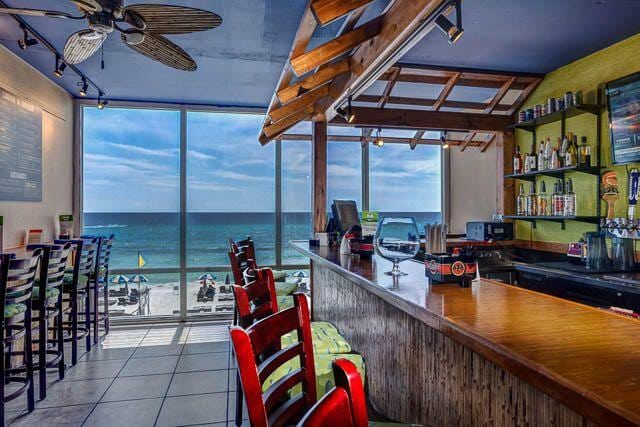 interior space with bar and ceiling fan