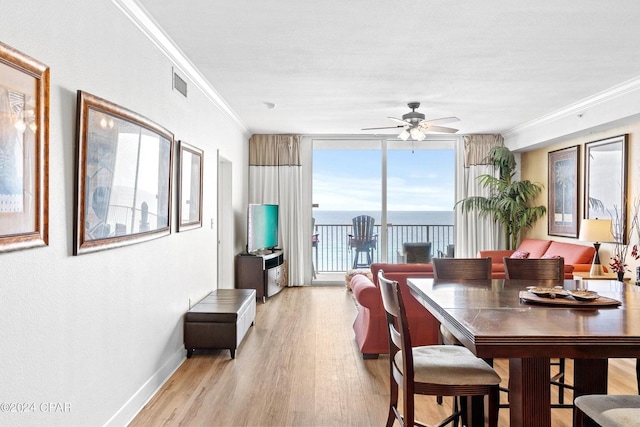 dining room featuring light hardwood / wood-style flooring, ceiling fan, and ornamental molding