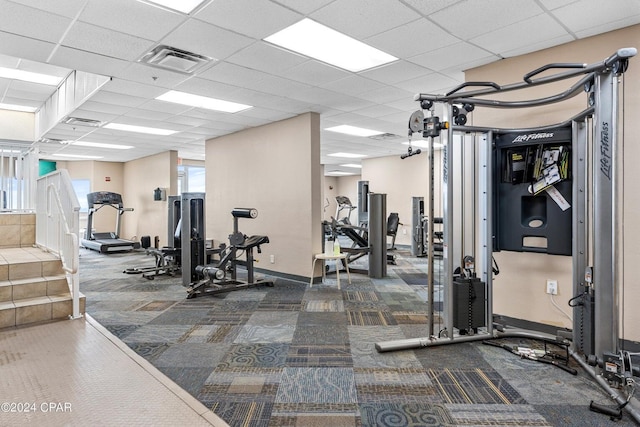 workout area with carpet, a wealth of natural light, and a drop ceiling