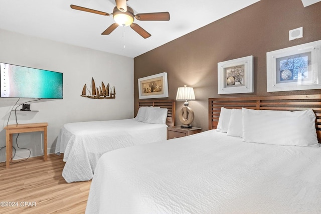 bedroom with ceiling fan and light hardwood / wood-style flooring