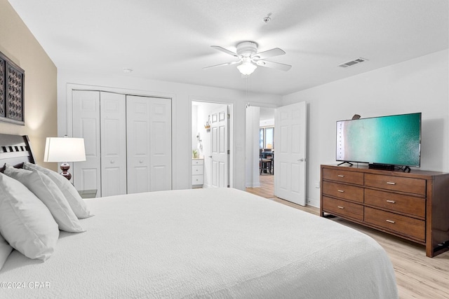 bedroom with a closet, light hardwood / wood-style flooring, and ceiling fan