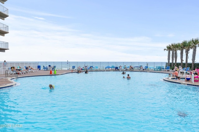 view of swimming pool featuring a water view