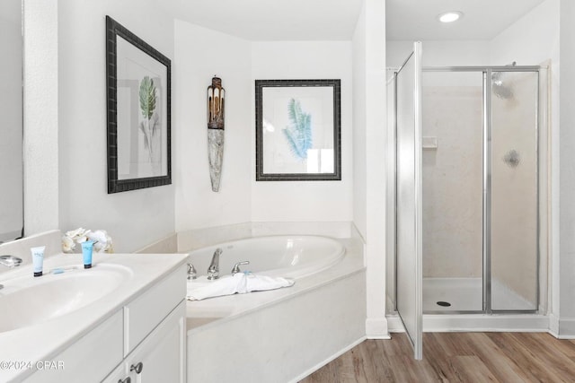 bathroom with vanity, hardwood / wood-style flooring, and separate shower and tub