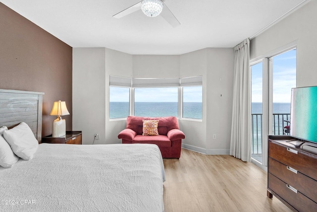 bedroom featuring ceiling fan, light hardwood / wood-style floors, and access to exterior