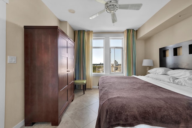 tiled bedroom with a closet and ceiling fan