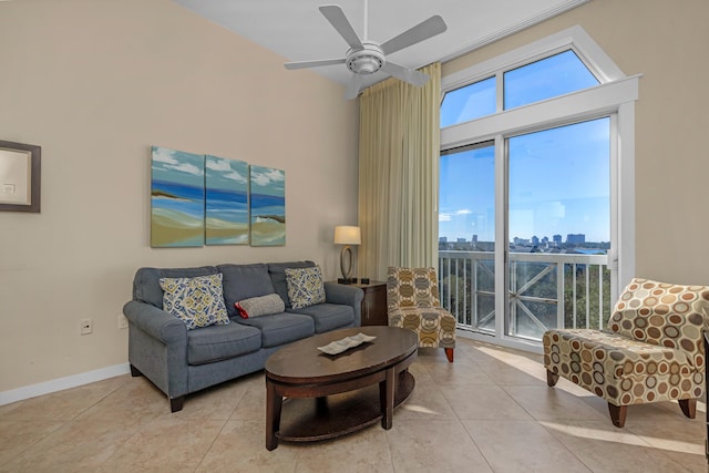 tiled living room featuring plenty of natural light, ceiling fan, and a high ceiling