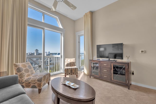 living room featuring ceiling fan and light tile flooring